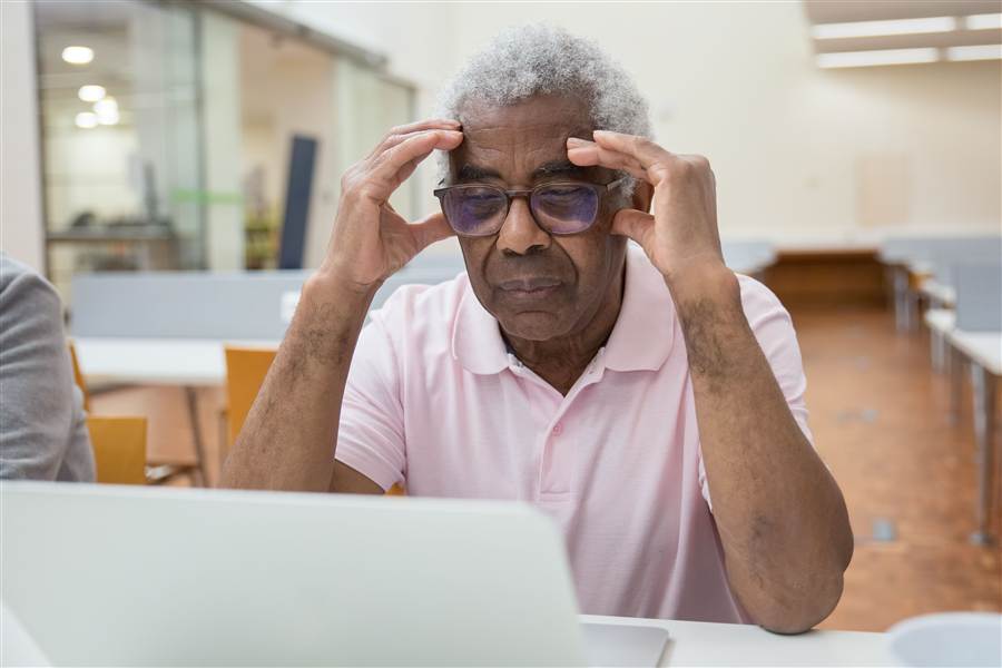 Elderly man focused and engaged while learning something new